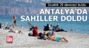 Sıcaklık 20 dereceyi buldu, Antalya'da sahiller doldu